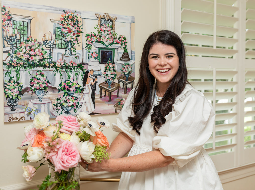 Ryan Harper Designs Arranging Flowers In Front of a Wedding Painting