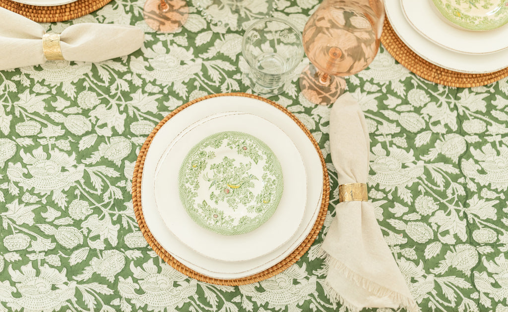 Ryan Harper Designs Green and White Floral Table Setting with Rose Colored Wine Glasses