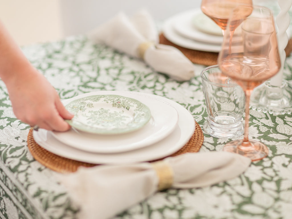 Ryan Harper Designs - Hand Placing Small Plate Down On Green and White Table Setting