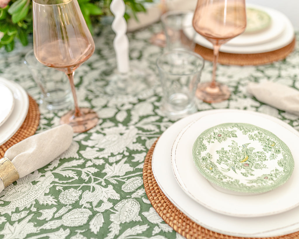 Ryan Harper Designs - Close Up of Green and White Floral Table Setting With Rose Colored Wine Glasses