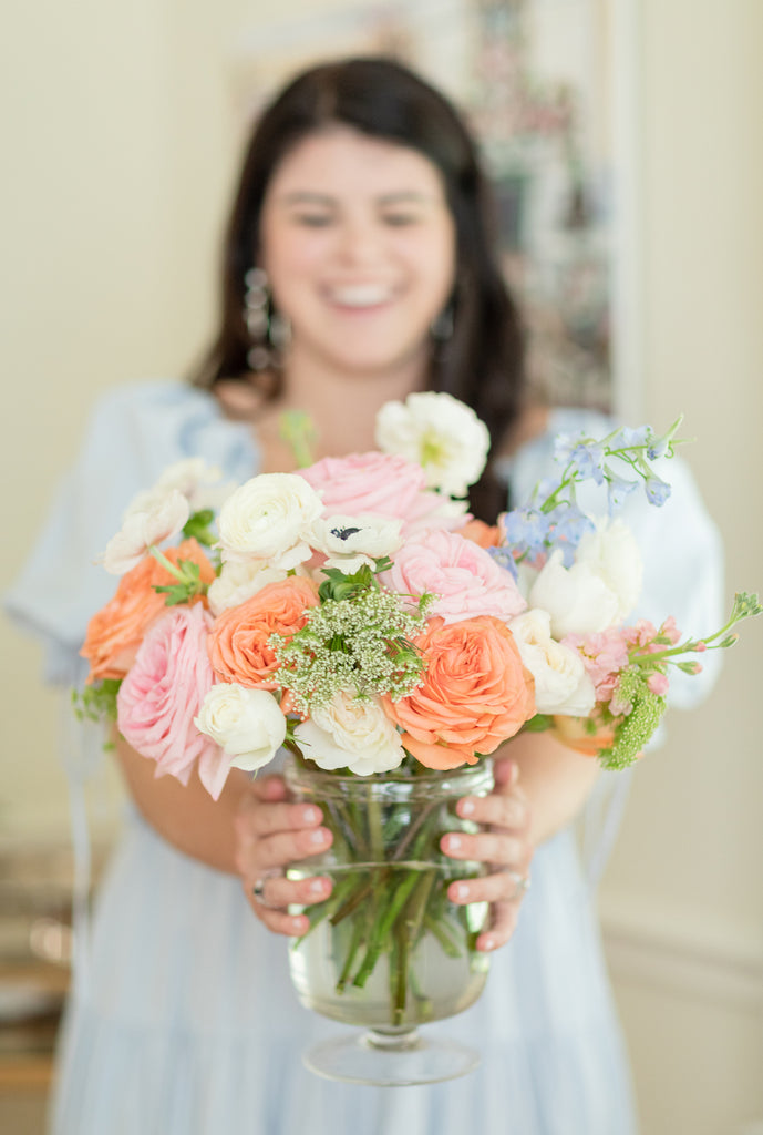 Ryan Harper Designs Holding Flower Arrangement